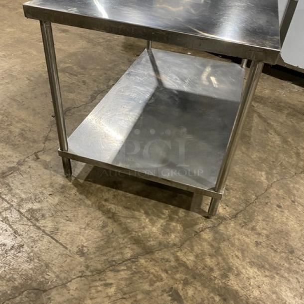 Commercial stainless steel equipment stand with single undershelf and sturdy legs. Polished finish. Good condition.