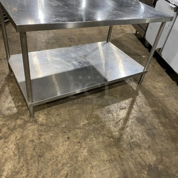 Commercial stainless steel equipment stand with single undershelf and sturdy legs. Pristine condition, ideal for kitchen use.