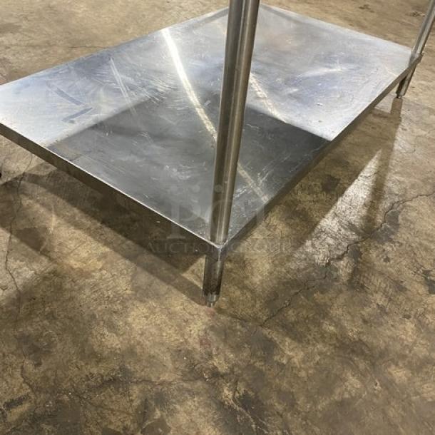 Commercial stainless steel single undershelf equipment stand on legs, durable and sturdy, ideal for kitchen use.