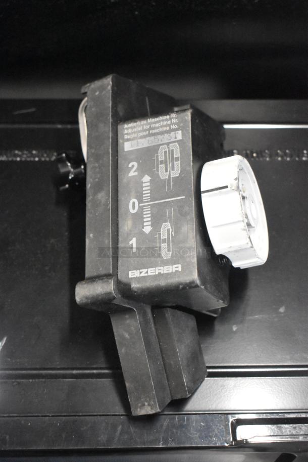 2023 Bizerba GSP H Commercial Meat Slicer features adjustable blade sharpener. Includes markings for settings.