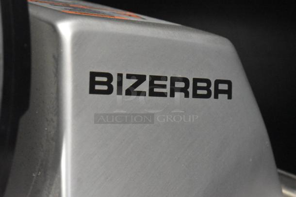 2023 Bizerba GSP H Commercial Meat Slicer, includes blade sharpener, shown on equipment stand. 120V, 1 Phase, branded "Bizerba."