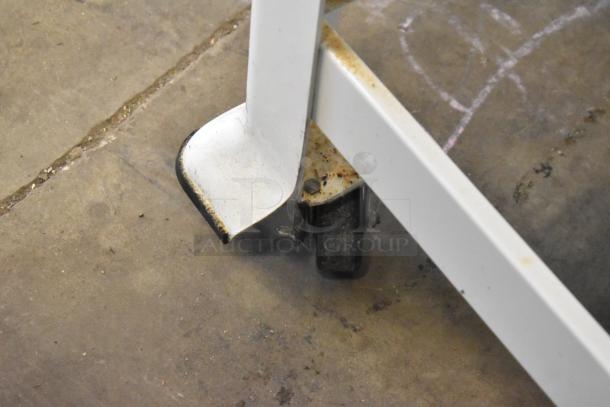 Oliver 797-32NC commercial bread slicer base close-up, showing support leg with slight rust. Model includes Pro Guard safety chute.