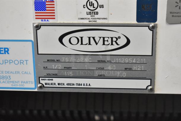 Oliver 797-32NC commercial bread slicer with safety chute, model plaque visible, 115 volts, 1 phase, UL listed.