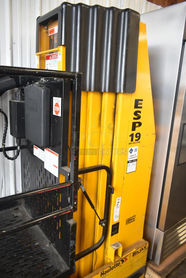 Bil Jax ESP-19 Haulotte industrial man lift, 450 lb capacity, model ESP-19, durable yellow frame, visible safety labels.