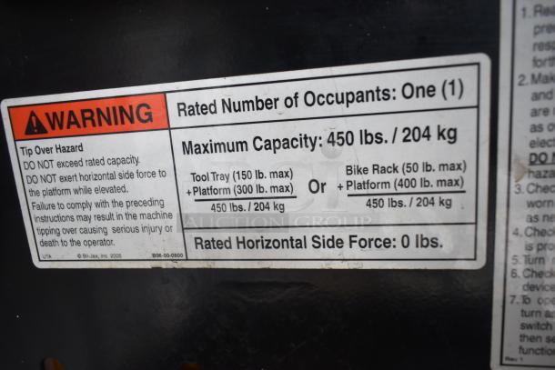 Label on Bil Jax ESP-19 Haulotte Man Lift, detailing 450 lb capacity and safety warnings against exceeding rated capacity.