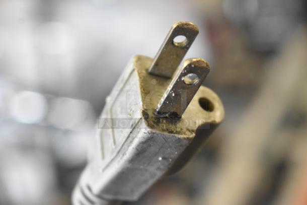 Close-up of a 120-volt power plug for a Bizerba SE 12 D US commercial meat slicer. Plug shows signs of wear.