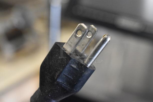 Close-up of a power plug for a Hobart HTi-7LH26 commercial countertop scale, indicating compatibility with 120/208-240 Volts, 1 Phase.