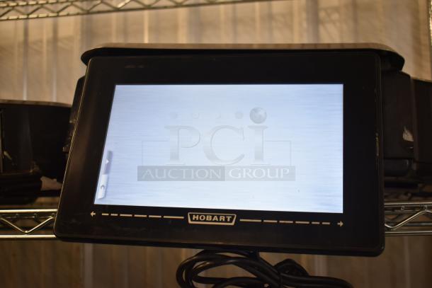 2016 Hobart HTi-7LH countertop scale, black, tested working. Missing power cord and back right leg. Model label visible.