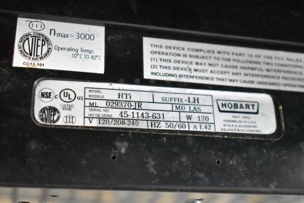 2016 Hobart HTi-7LH commercial scale label showing model, serial number, voltage, and certifications. Missing power cord and leg.