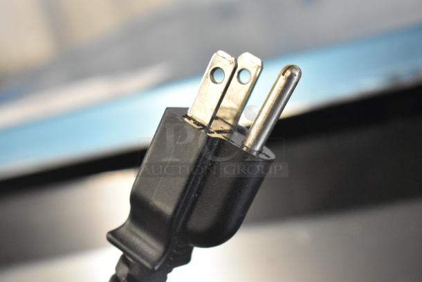 Close-up of a three-prong electrical plug for the 2018 Hobart HTi-7LH26 Commercial Countertop Scale. Plug is black and in working condition.