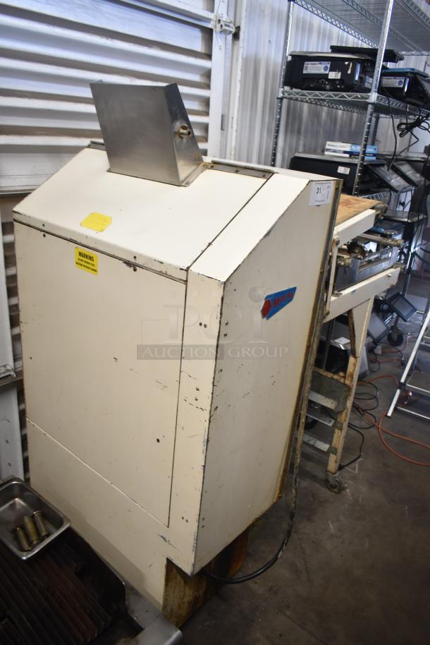 Moline commercial floor dough sheeter on casters, 125V, 1 phase, showing wear. Visible "Moline" label and warning sticker.