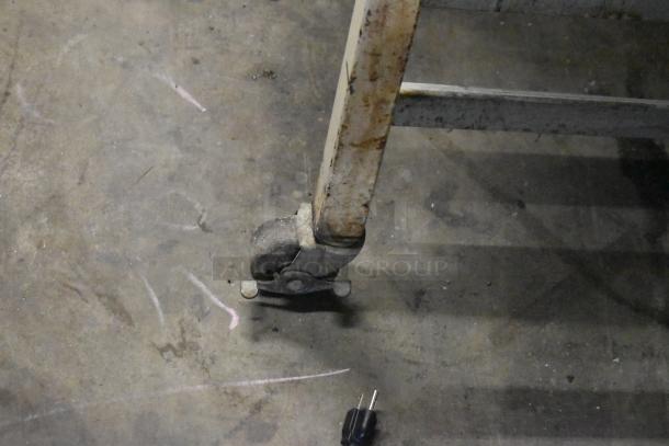 Moline commercial dough sheeter on casters, showing a single caster wheel and power plug. 125 volts, 1 phase.