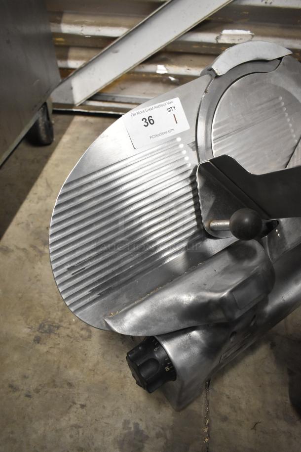 Berkel commercial countertop meat slicer with blade sharpener, 115 volts, 1 phase. Metal finish, tagged PCIauctions.com, item 36.