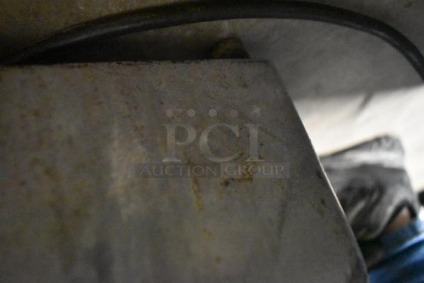 Berkel commercial countertop meat slicer, includes blade sharpener. Requires 115 volts, 1 phase. Appears used, condition unclear.