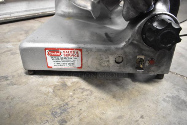 Berkel commercial meat slicer with blade sharpener, 115 volts, used condition, visible sales and service label.