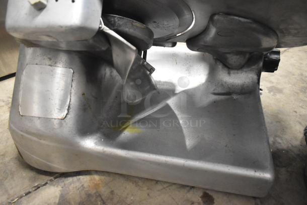 Berkel commercial countertop meat slicer with blade sharpener, 115 volts, 1 phase, shows wear and scratches, sturdy base.