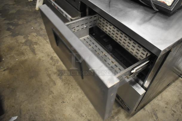 2016 True TUC-27F-D-2-HC commercial freezer, 2 drawers, on casters, stainless steel, 115 volts, model label visible.