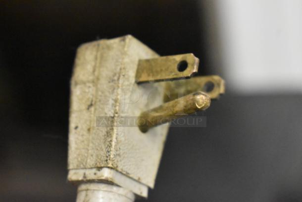Close-up of a worn electrical plug for the 2016 True TUC-27F-D-2-HC 2 Drawer Undercounter Freezer.