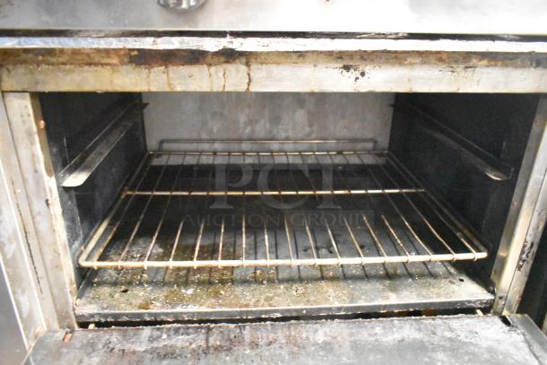 American Range AR-6 commercial oven interior showing wire rack. Oven exhibits signs of use with visible residue.