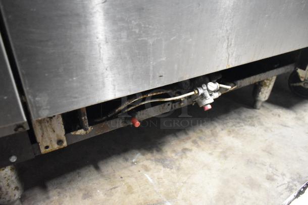 American Range AR-6 commercial gas range base. Features durable construction, showing signs of wear.