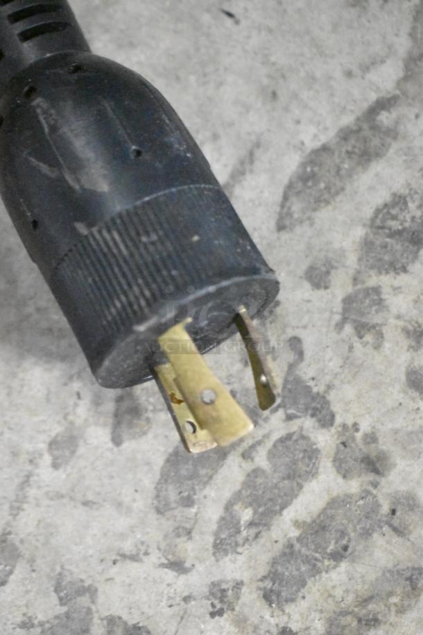 Close-up of the plug from a CresCor H138NPS36CLCMQRL hot food holding cabinet, showing its connection type.