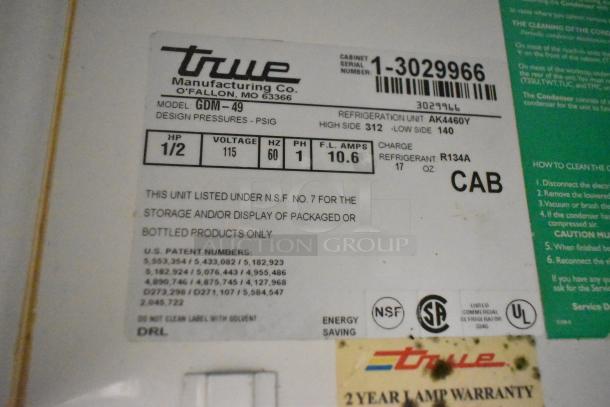 True GDM-49 Commercial 2-Door Cooler label, 115 volts, 1 phase, NSF No. 7 certified, refrigerant R134A, model and specs listed.