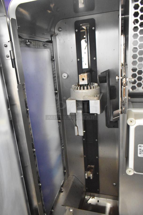 LATE MODEL JBT 2nd-Gen-MFJ-HE Fresh N Squeeze citrus juicer; commercial casters, 115V, 1 phase. Interior view.