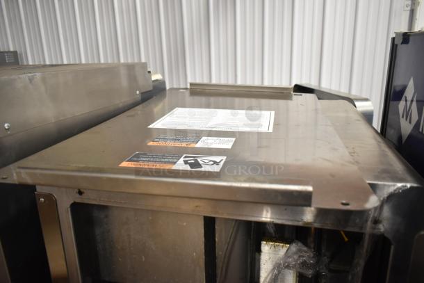 JBT Fresh N Squeeze 2nd-Gen MFJ-HE citrus juicer, floor style, on commercial casters, stainless steel, 115V, 1 phase, shown with labels.