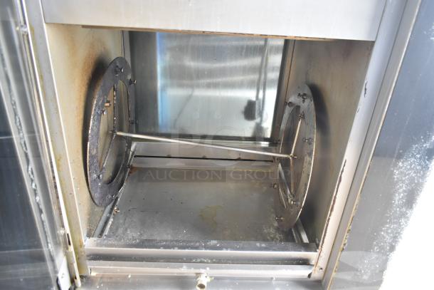 Fri-jado TDR7+7 P electric rotisserie oven interior, used condition, visible wear, broken glass noted, on commercial casters.