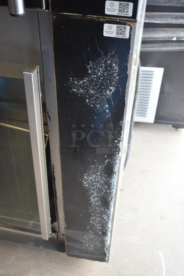 Fri-jado TDR7+7 P rotisserie oven, broken glass, black exterior, commercial casters, 208V, 3 phase, maintenance tags visible.