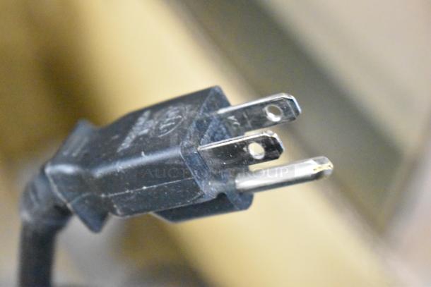 Close-up of a power plug for a 2022 Sharp R-21LVF Commercial Microwave Oven, 120 Volts, 1 Phase.