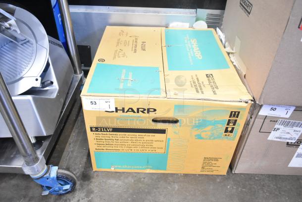 2024 Sharp R-21LVF Commercial Microwave Oven in original packaging, features 120 Volts, 1 Phase. Box displays model details.