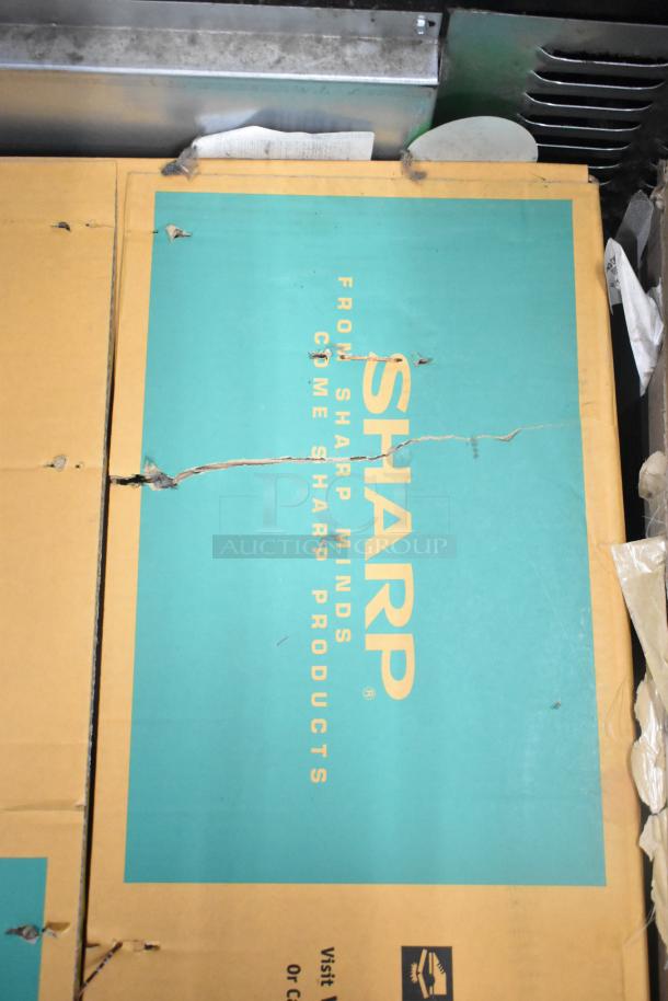 2024 Sharp R-21LVF Commercial Microwave Oven packaging, model and branding visible, indicating new condition.