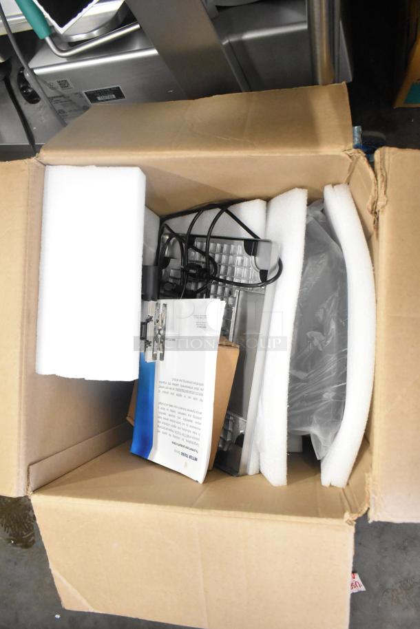 Mettler Toledo FreshWay Scale in box with packaging, cables, and manual. Voltage: 100-240V, 1 Phase.