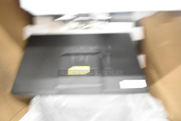 Blurry image of Mettler Toledo FreshWay Scale. Black surface, 100-240V, 1 Phase, partially visible yellow tag.