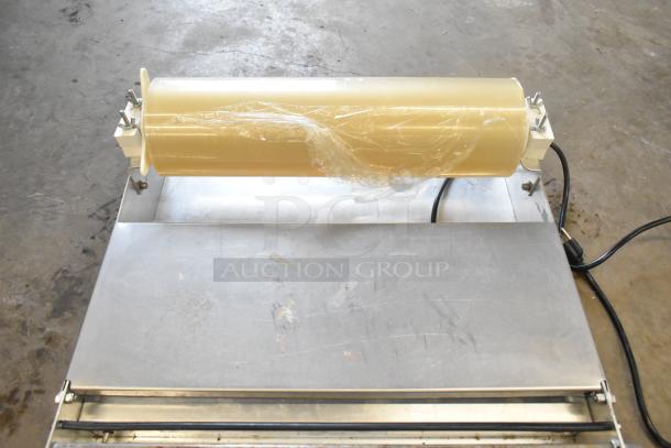 Countertop Wrapping Station Model 5000156, 115 Volts, 1 Phase, metal surface, light wear, roll holder included.