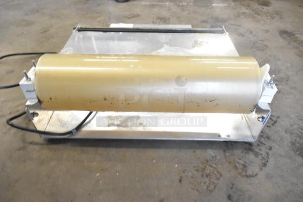 Countertop Wrapping Station Model 5000156, steel base with plastic roller. Runs on 115 volts, 1 phase. Some wear visible.