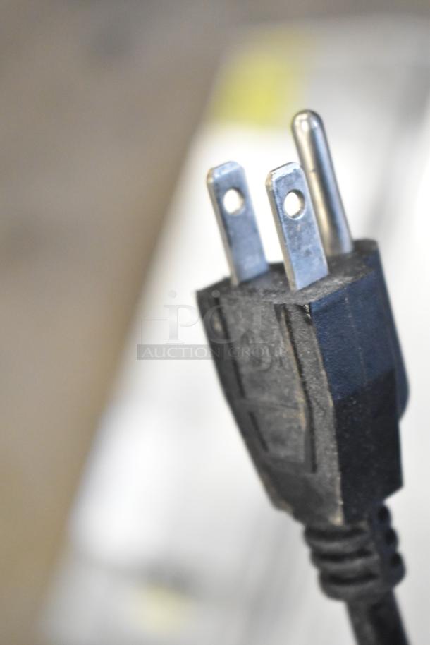 Close-up of a power cord plug from the 5000156 Countertop Wrapping Station, 115V, 1 Phase. Clean condition.
