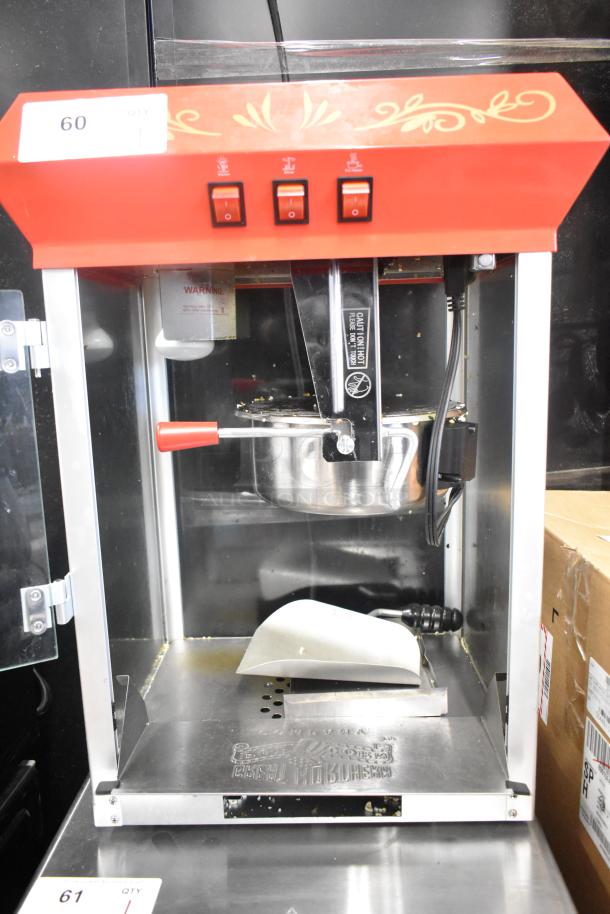 Great Northern Co 83-DT5634 countertop popcorn machine, red and silver, 120 volts, 1 phase, three control switches.