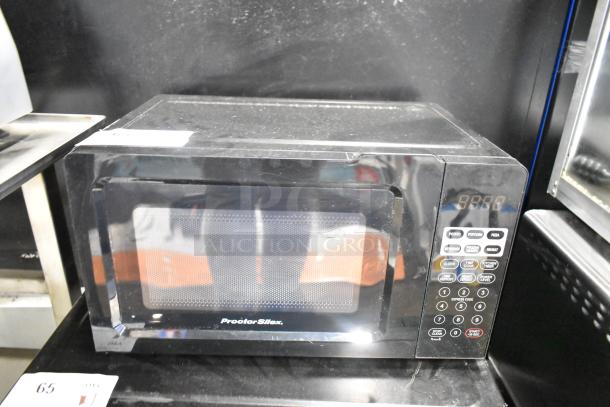 Proctor Silex PS-P70T20AL-V1B countertop microwave oven, black, with control panel, visible wear, includes plate, 120V.