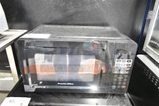 Proctor Silex PS-P70T20AL-V1B countertop microwave oven, black, with control panel, visible wear, includes plate, 120V.