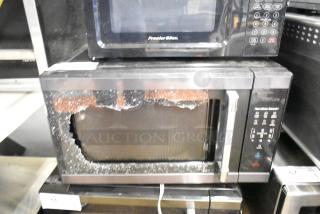 2024 Hamilton Beach HB61B100027880 microwave with broken glass door, countertop model, 120V, 1 phase, includes plate.