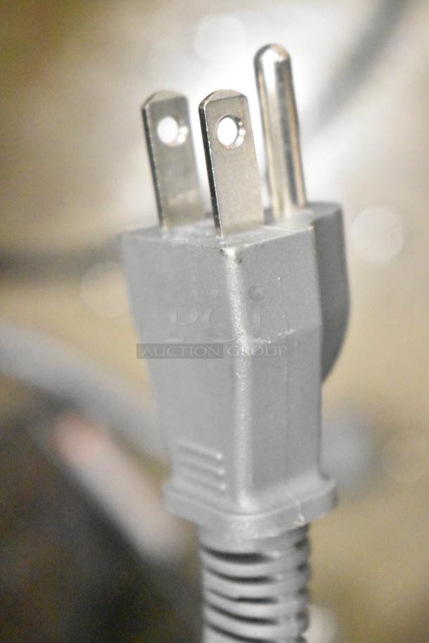Close-up of a power plug for 2024 Hamilton Beach HB61B100027880 countertop microwave, 120 volts, 1 phase. Check for damage.