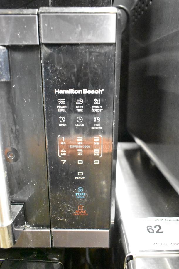 Hamilton Beach HB61B100027880 microwave oven, black, with user interface panel. Notable for broken glass. 120V.