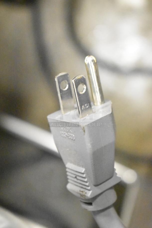 Electric plug of 2024 Hamilton Beach HB61B100027880 Countertop Microwave, 120V, visible prongs and plug markings.