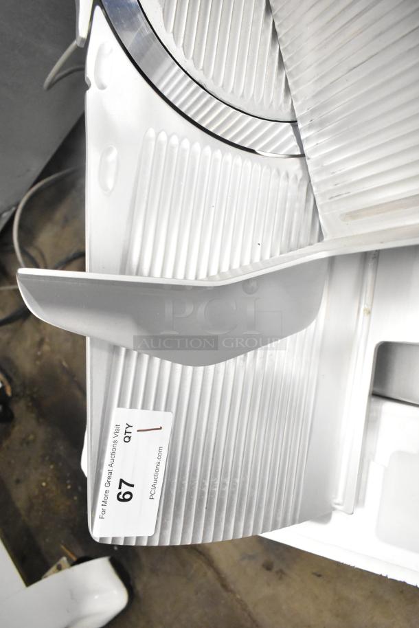 Bizerba GSP HD commercial meat slicer, 120V, 1 phase, in good condition. Auction tag number 67 visible.