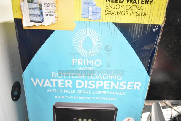 Primo Bottom Loading Water Dispenser in original box, featuring single-serve coffee maker. Box shows brand markings and promo offers.