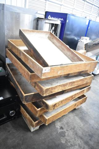 Stacked vintage wooden bins, 17 pieces, weathered condition, labeled with numbers, suitable for storage or decor.