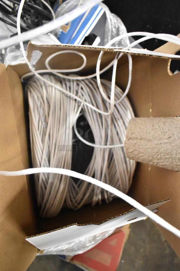 Pallet lot with Belden 1700A cable, Paige cable, and assorted wires in a cardboard box, suitable for electrical projects.