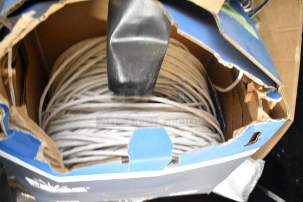 Pallet lot with Belden 1700A, Paige cable, and wires. Cables coiled in damaged box. Ideal for bulk purchase.